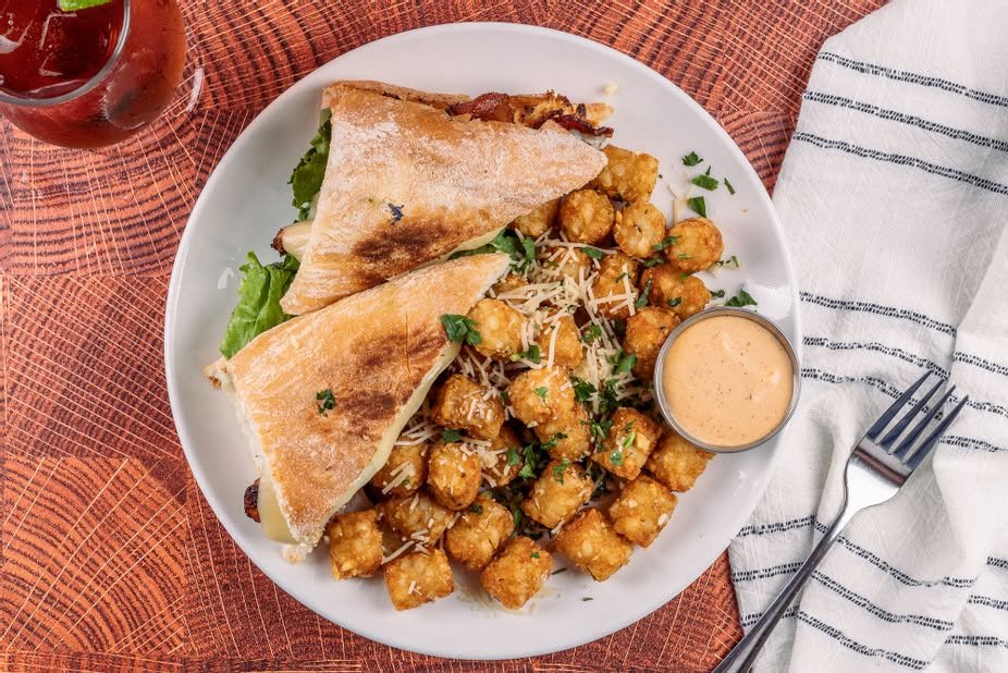 Toasted club sandwich with parmesan tater tots
