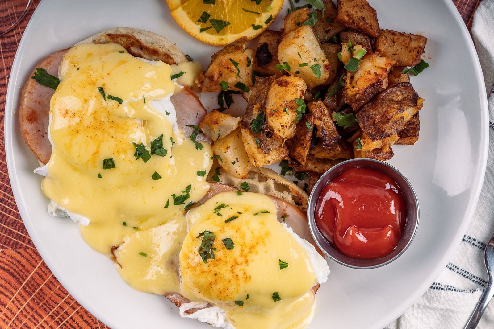 Eggs benedict with hollandaise and breakfast potatoes