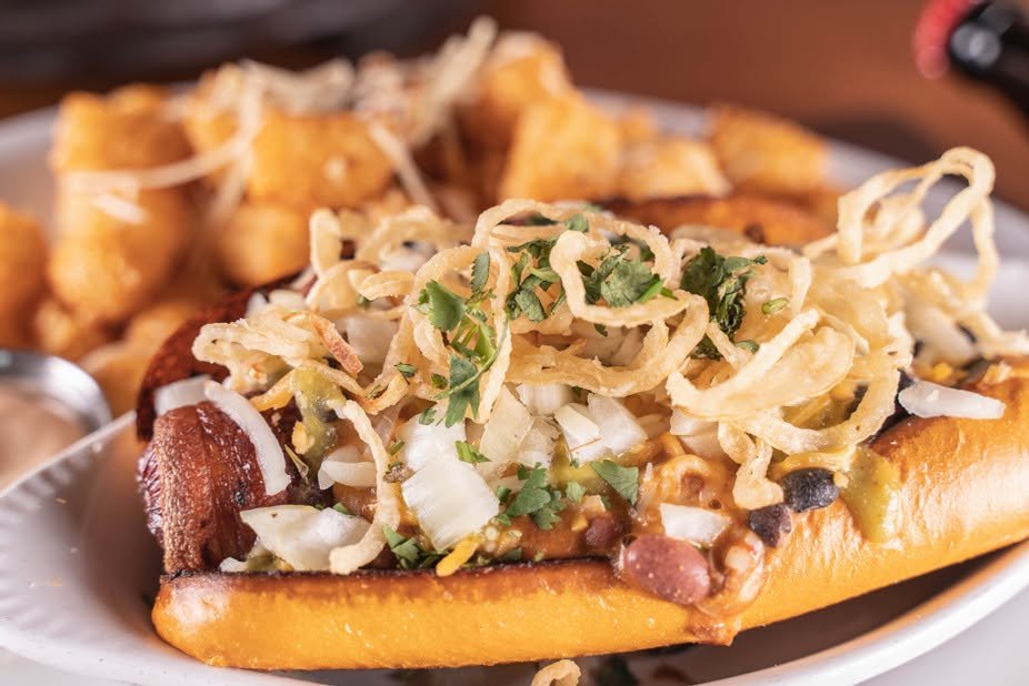 Loaded gourmet hot dog with crispy onions